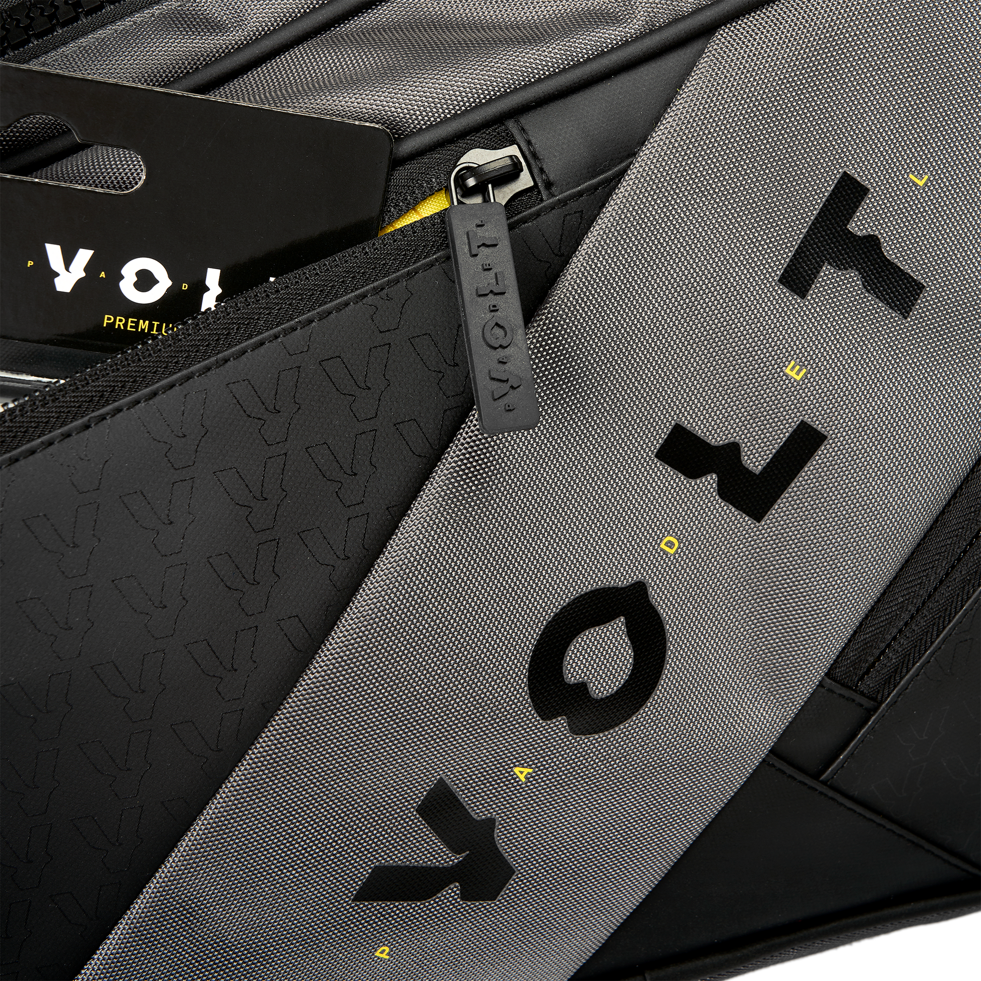 Close-up of Volt’s grey XL padel bag, showing the textured black and grey fabric, Volt logo details, and branded zipper pull.