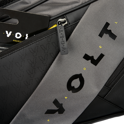 Close-up of Volt’s grey XL padel bag, showing the textured black and grey fabric, Volt logo details, and branded zipper pull.
