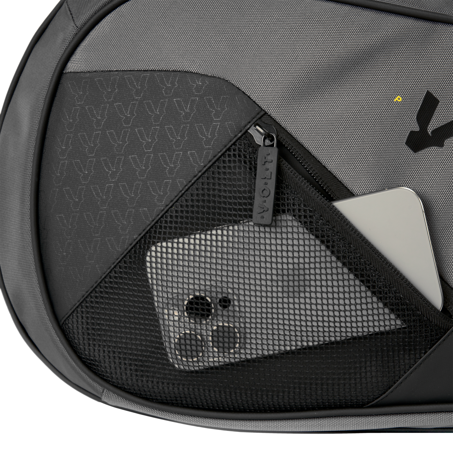 Close-up of Volt’s grey XL padel bag showing a black mesh pocket with a smartphone and a silver laptop inside.