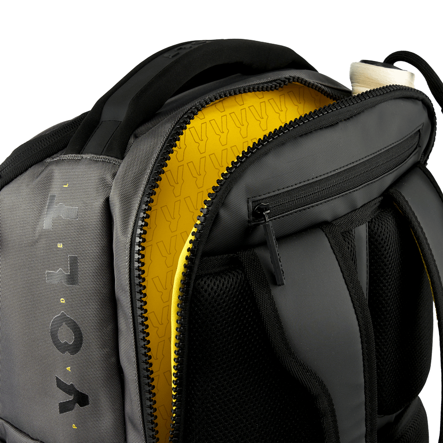 Open top view of the Volt Padel backpack showing the yellow lining.