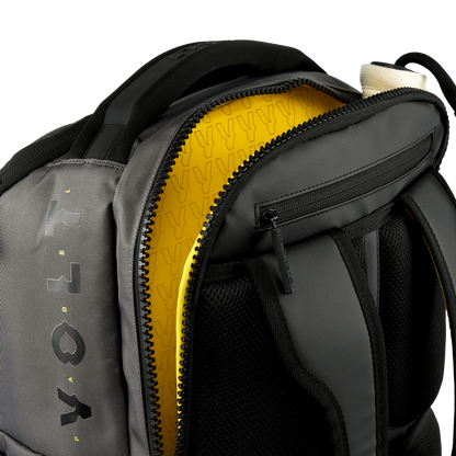 Open top view of the Volt Padel backpack showing the yellow lining.