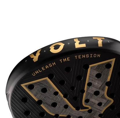 Top detail of the Volt 1000 V5 padel racket, showcasing the metallic gold design with its 24K Silver Aluminized Carbon pattern inside the big logo.