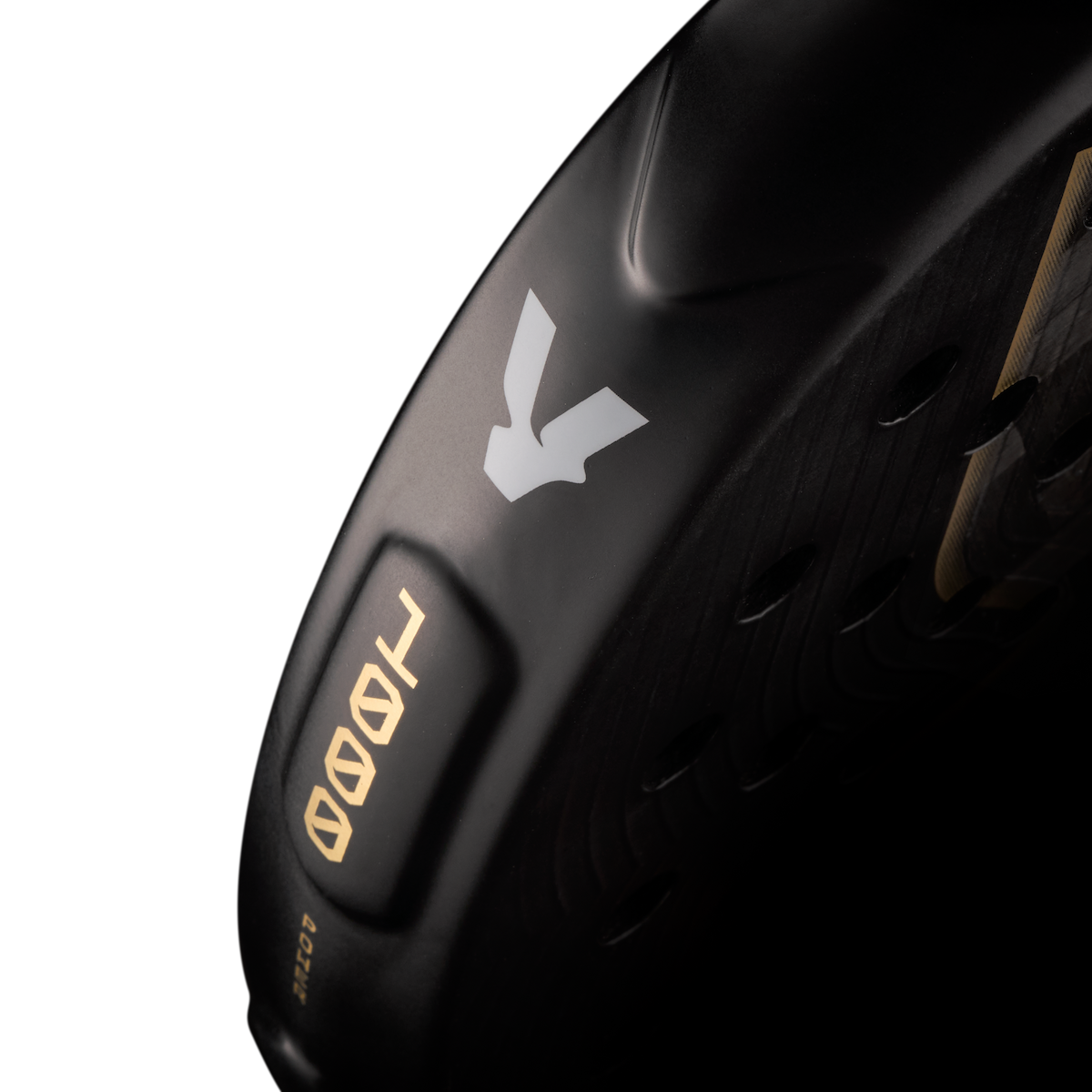 Side detail of the Volt 1000 V5 padel racket, showcasing the classy black and white V logo, the metallic gold 1000 numbers and highlighting the racket shape details on the side.