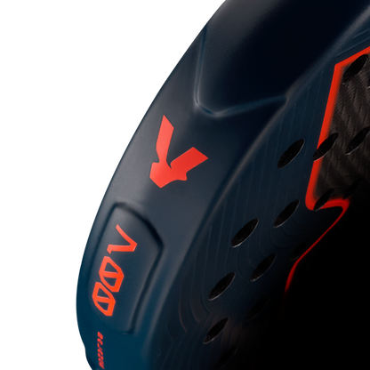 Side detail of the Volt 700 V5 padel racket, showcasing the beautiful dark blue and fluor orange V logo and highlighting the racket shape details on the side.
