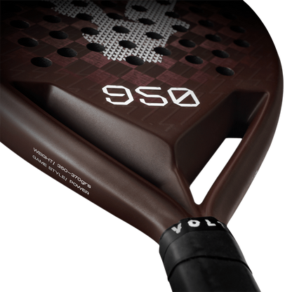 Close-up of the Volt 950 V4 padel racket's lower face, featuring the weight specifications and sleek brown carbon finish.